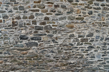 Texture of a stone wall. Old castle stone wall background. Wall made of wild stone. Natural...