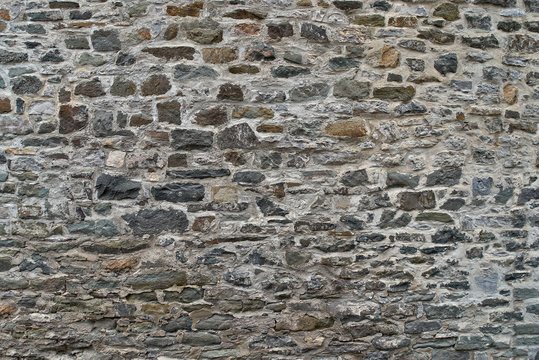 Texture of a stone wall. Old castle stone wall background. Wall made of wild stone. Natural background