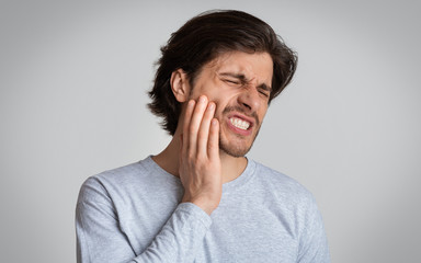 Man suffering from terrible strong teeth pain - obrazy, fototapety, plakaty