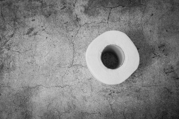 Basic hygiene article shortage. Top view of rolls of toilet paper on gray texture background