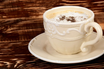 cups with coffee and milk foam sprinkled with dark chocolate