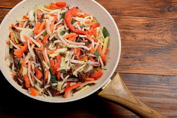frozen Chinese vegetables and mushrooms in a frying pan