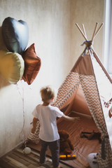 Children's wigwam for a beige boy. In the nursery. © Дмитрий Чапурин