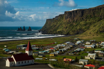 Fototapeta na wymiar Chunch in Vik with view for Reynisdrangar bazalt rock, Iceland
