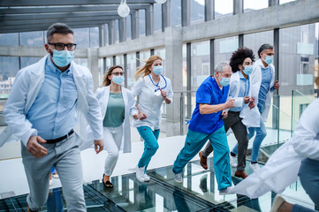 Group of doctors running in corridor of hospital, emergency concept. - Powered by Adobe