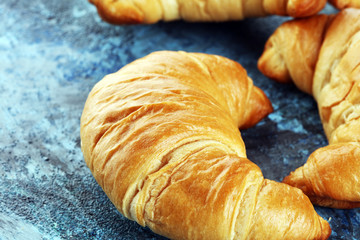 freshly baked croissants on rusti background. bakery croissant concept