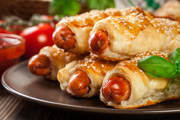Rolled hot dog sausages baked in puff pastry