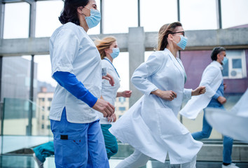 Group of doctors running in corridor of hospital, emergency concept.