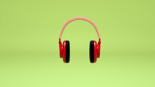 3D animation headphones spinning on a green background, loop animation. 3d rendering motion cartoon style music technology concept pastel colorful scene