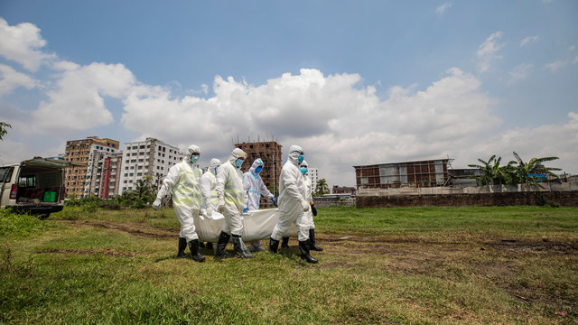 Members of Al-Markazul Islami Bangladesh carry a Person who died by Coronavirus to the grave for funeral at Khilgaon Taltola Graveyard in Bangladesh on Friday morning April 24,2020.