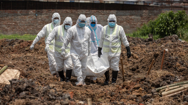 Members of Al-Markazul Islami Bangladesh carry a Person who died by Coronavirus to the grave for funeral at Khilgaon Taltola Graveyard in Bangladesh on Friday morning April 24,2020.