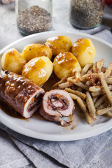 Pork rolls stuffed with vegetables served with potatoes