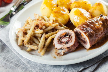 Pork rolls stuffed with vegetables served with potatoes