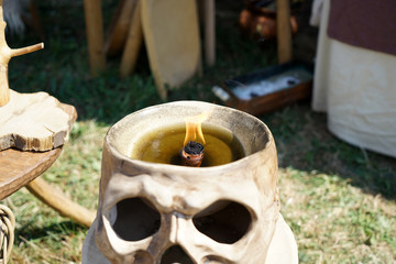 burning candle in a skull