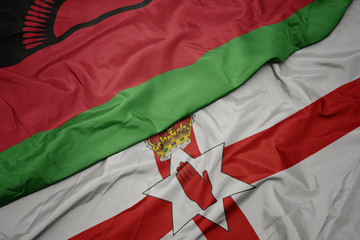 waving colorful flag of northern ireland and national flag of malawi.