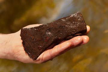 Man found rusty iron metal axe in river water by magnet