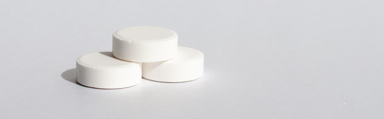 Tablets in blister and gray bottle antiseptikum lies on the steel. Place for the label.Medical topic.