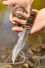 Man found hunting knife in river water by magnet