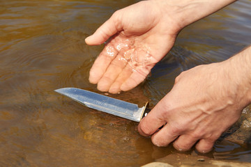 Man found hunting knife in river water by magnet