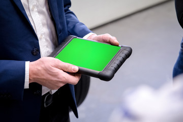 Man is holding a tablet, mobile device
