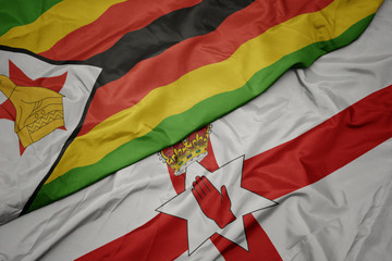 waving colorful flag of northern ireland and national flag of zimbabwe.