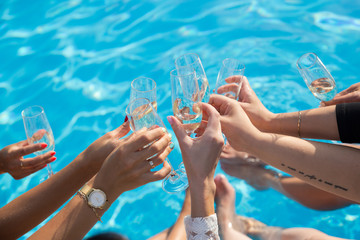 Women make a toast by the pool