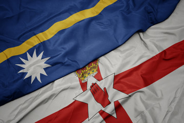 waving colorful flag of northern ireland and national flag of Nauru .