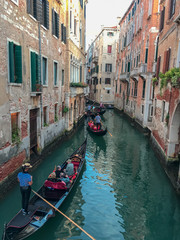 Obraz na płótnie Canvas Gondolas on narrow canal in Venice, Italy