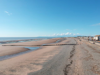An empty beach on a hot summers day empty due to the coronavirus lockdown during the corona virus covid 19 epidemic pandemic. Empty roads and beaches enforced by the government.