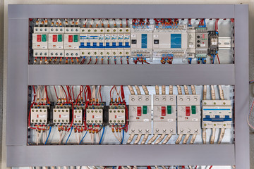 Motor protection circuit breakers, remote access controller, phase and voltage control relays, thermostat and contactors with front additional contacts in the electrical Cabinet.