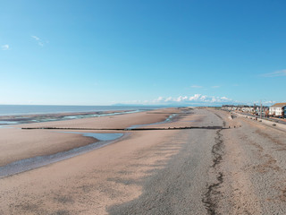 An empty beach on a hot summers day empty due to the coronavirus lockdown during the corona virus covid 19 epidemic pandemic. Empty roads and beaches enforced by the government.