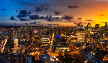 Vancouver, British Columbia, Canada. Aerial Panoramic View of Modern Downtown City during Twilight. Dramatic Colorful Sunset Sky Composite.