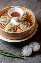 oriental dish manti dough with meat and sauce on concrete background