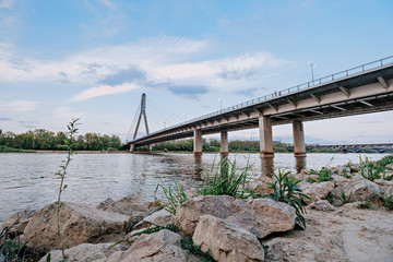 Fototapeta premium Low water level in the Vistula River in Warsaw. River embankment near Poniatowski Bridge