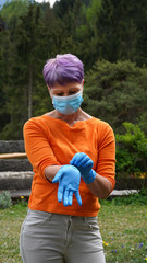Woman in protective face mask and gloves. Woman has headache. Tired sick woman in medical face mask and gloves. Coronavirus symptoms. Covid-19 concept. Coronavirus quarantine.