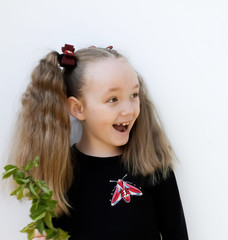 little girl rejoices delighted on a white background