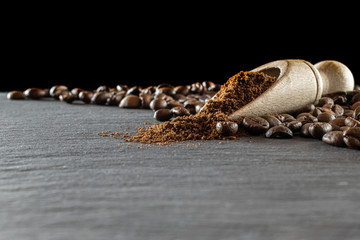 Cafe coffee background. Espresso beans for food, drink caffeine breakfast on black. Brown roasted coffee seeds isolated for energy mocha, cappuccino ingredient. Macro photography, soft focus