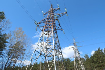High voltage pole against the blue sky