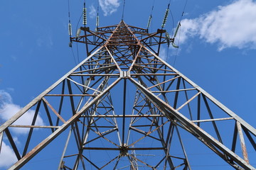 High voltage pole against the blue sky