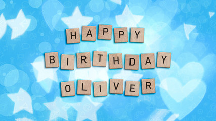 Happy Birthday Oliver card with wooden tiles text. Boys birthday card in blue. This image can be...