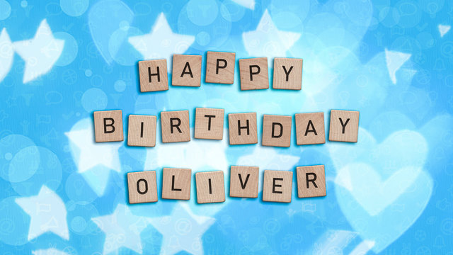 Happy Birthday Oliver card with wooden tiles text. Boys birthday card in blue. This image can be used for a eCard or a print postcard.