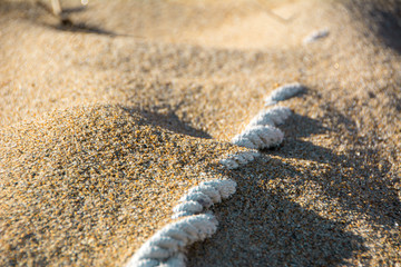 White Rope Coming Out of Sand
