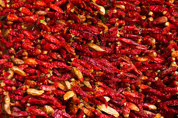 Fototapeta premium Colorful chili peppers hanging for sale at a market