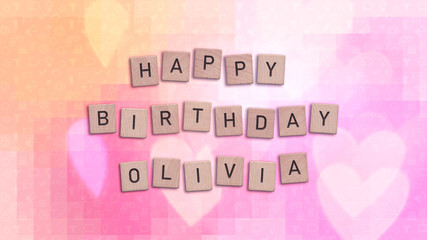 Happy Birthday Olivia card with wooden tiles text. Girls birthday card in rainbow colors. This image can be used for a eCard or a print postcard.