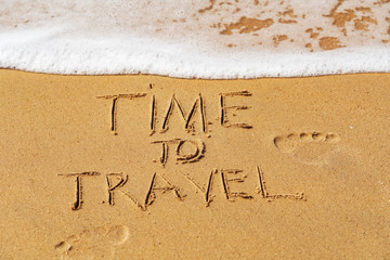 Time to Travel written on the beach
