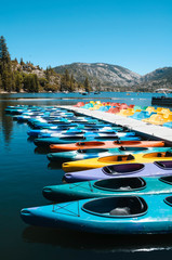 Colorful kayaks lined up in Pinecrest Lake, California