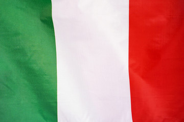 Fabric texture flag of Italy. Flag of Italy waving in the wind. Italy flag is depicted on a sports cloth fabric with many folds. Sport team banner.