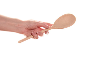 Female hand with a wooden spoon