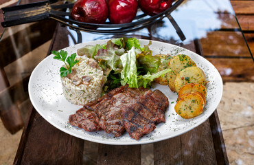 Beef steak with potatoes and rice in isolated white background