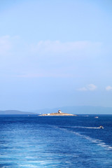 Boats and lighthouse on a small island near town Hvar, on island Hvar, Croatia. 